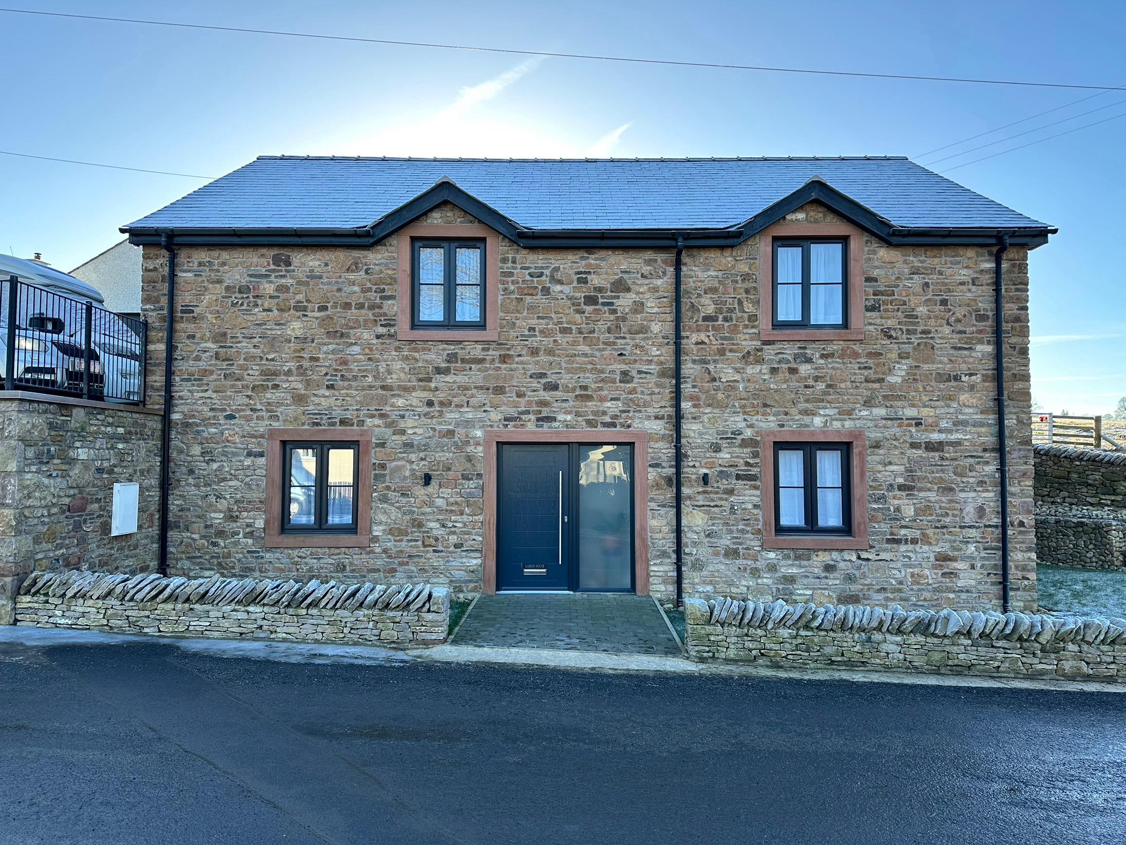 A new build 5 bed  eco friendly house in Morland, near Penrith, Cumbria. The house is a timber framed structure, highly insulated, with solar power and battery back-up, an air source heat pump, and a rainwater reclamation system. It is clad in traditional Cumbrian stone, with red sandstone detailing